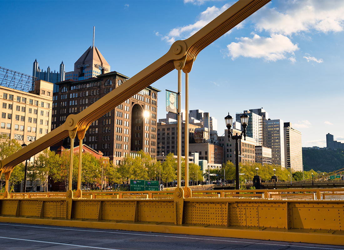 Pittsburgh, PA - View of Commercial Buildings Next to the River in Downtown Pittsburgh Pennsylvania on a Sunny Day from a Steel Bridge